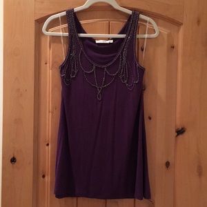 Long, purple tank a bejeweled chest!